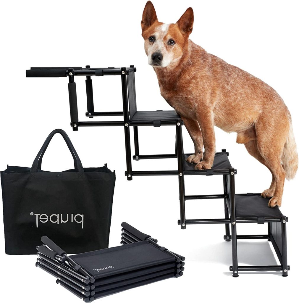This picture depicts a dog climbing up the PiuPet foldable stairs. The foldable stairs feature a strong metal frame with wide PVC steps designed to support dogs up to 80kg.